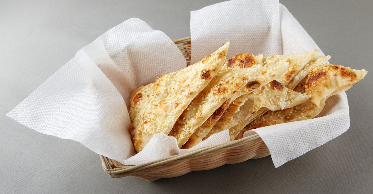 a basket filled with sliced focaccia bread showcasing a rustic presentation on a grey backdrop 1