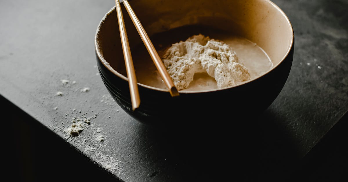 a bowl of flour with chopsticks captured in a dark and moody setting ideal for cooking themes 2