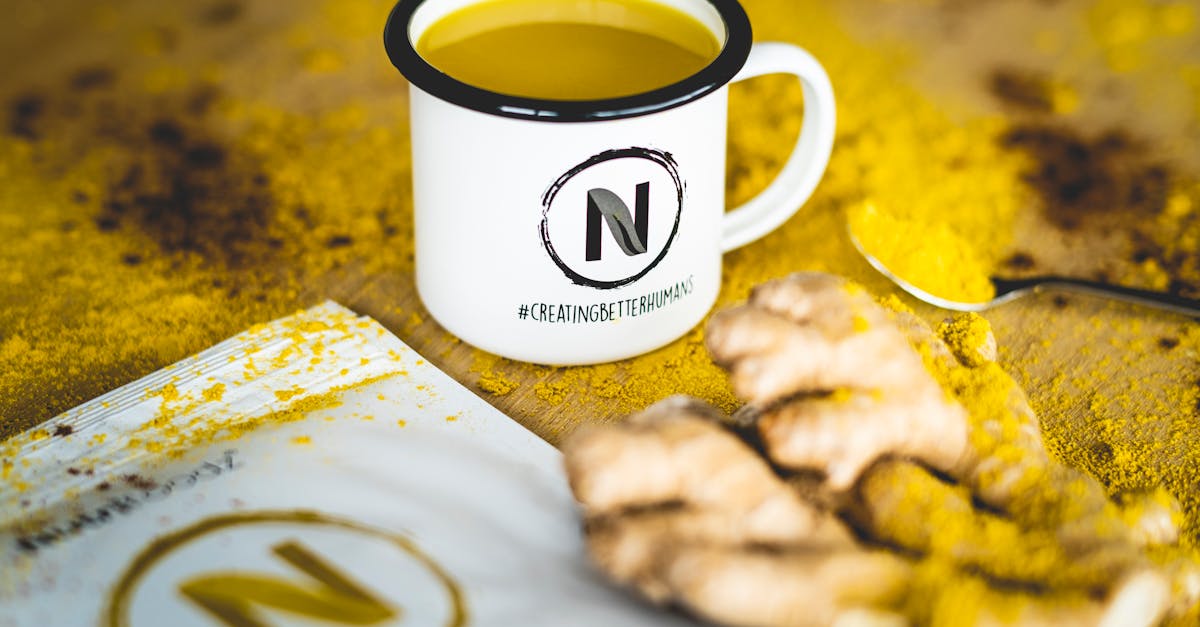 a close up image of turmeric tea with fresh ginger root perfect for health and wellness themes