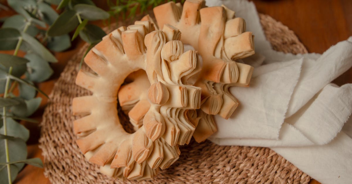 a close up of traditional paraguayan chipa bread on a woven mat with white cloth showcasing artistr