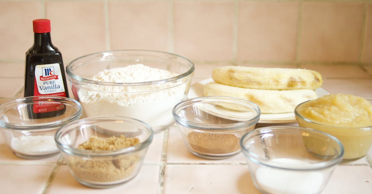 a collection of ingredients for baking banana bread including flour bananas and vanilla