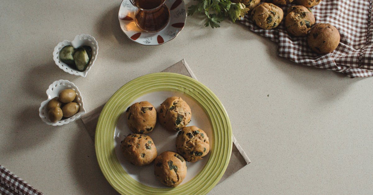 a cozy flat lay of homemade herb muffins served with tea olives and vegetables