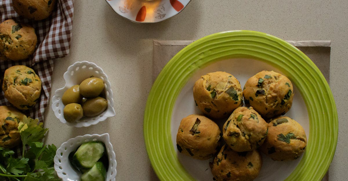 a cozy setting with herb scones tea olives and cucumbers on a table