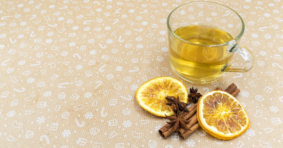 a cozy still life of herbal tea with dried orange slices cinnamon and star anise