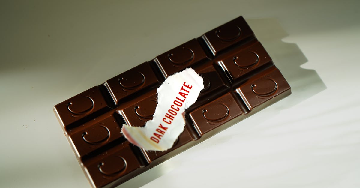a dark chocolate bar with a torn label reading dark chocolate photographed under natural light