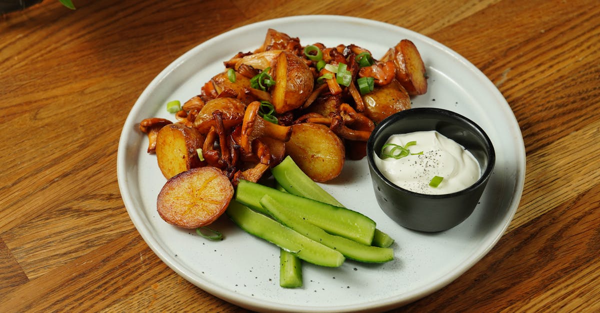 a delectable plate of roast potatoes served with chanterelle mushrooms and fresh cucumbers