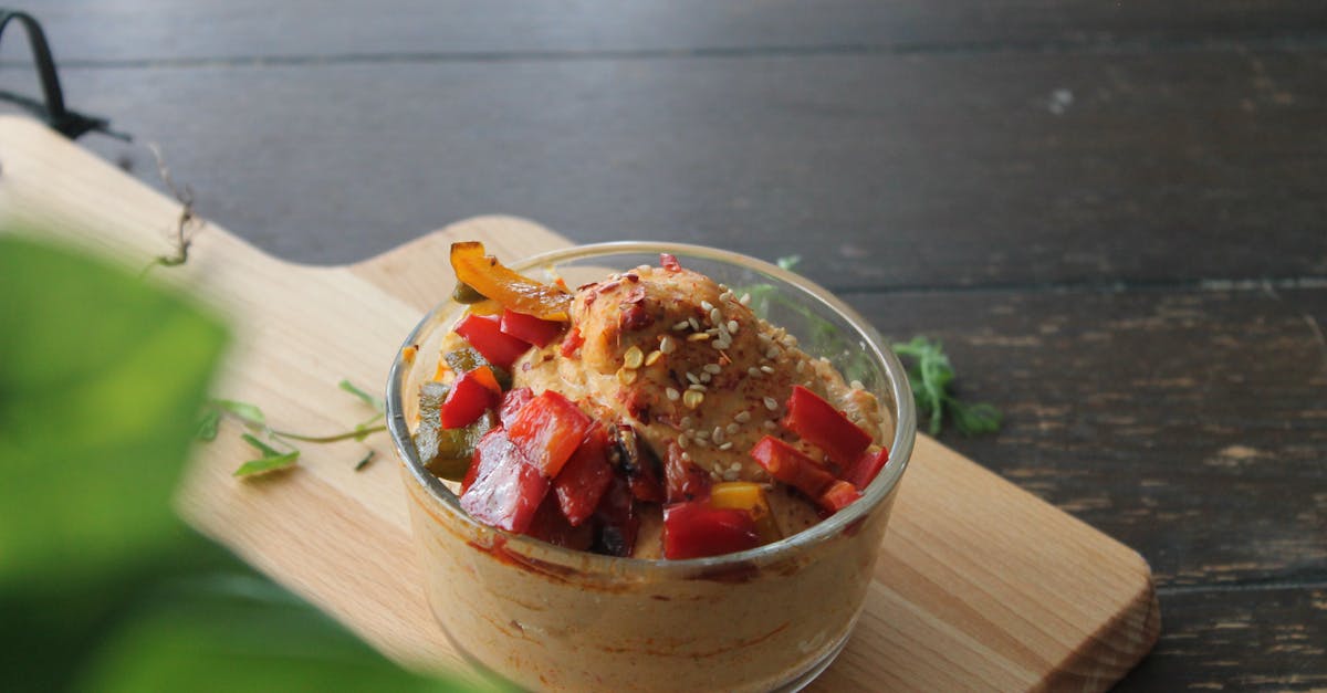 a delicious bowl of roasted vegetable hummus on a wooden cutting board ideal for healthy snacking