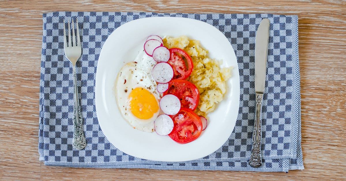 a delicious breakfast featuring fried eggs tomatoes radishes and smashed potatoes
