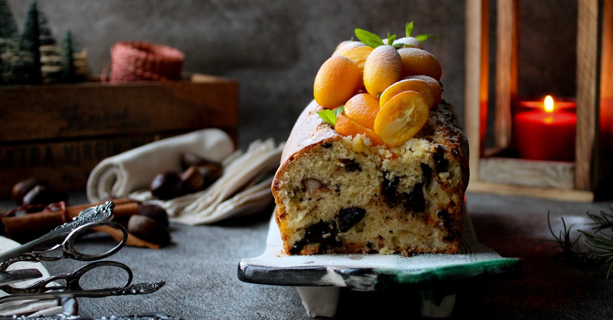 a delicious fruitcake topped with kumquats surrounded by festive christmas decor perfect for holida 1