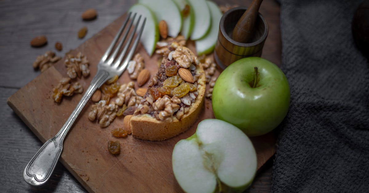 a delicious rustic tart with walnuts raisins and fresh green apples on a wooden board