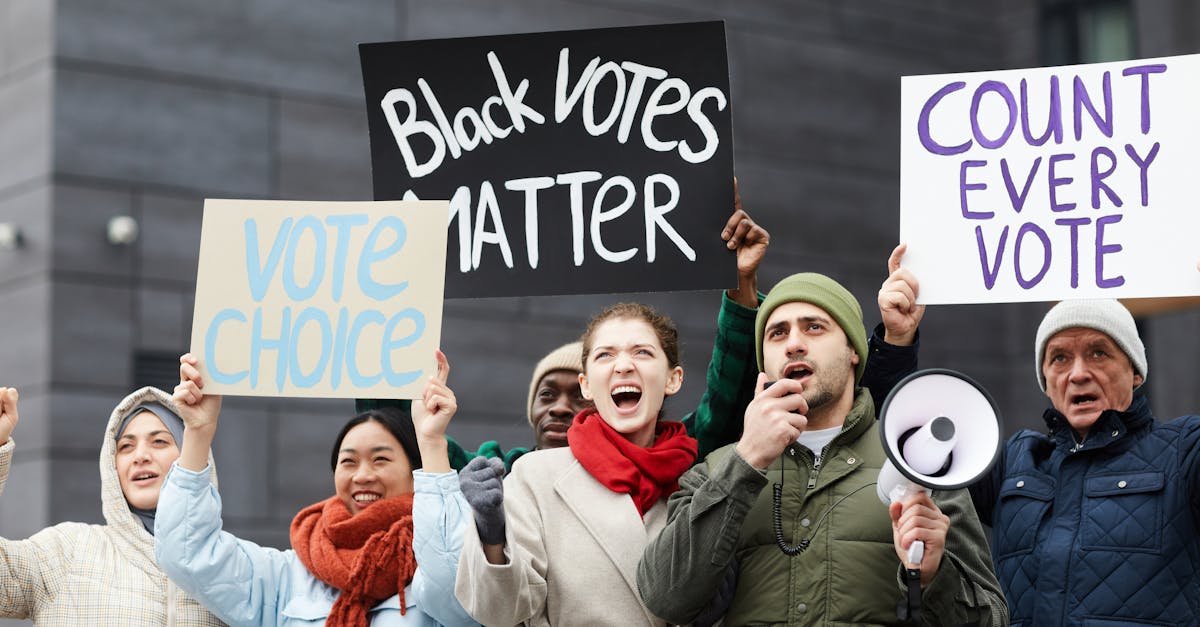 a diverse group of people protesting for voting rights with signs and megaphone outdoors
