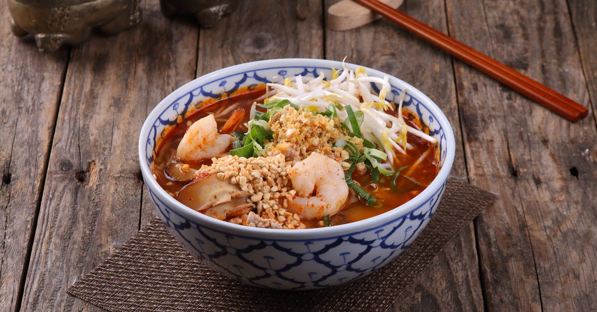 Home a flavorful vietnamese shrimp noodle soup garnished with peanuts and sprouts