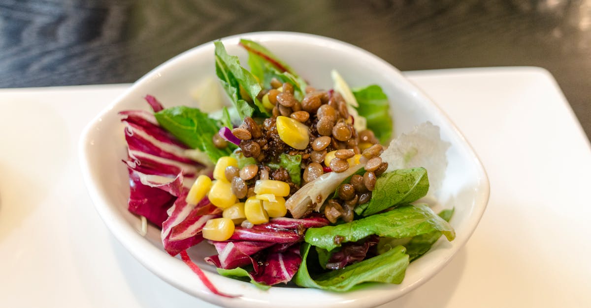 a fresh and delicious vegetable salad featuring lentils and corn served in a white bowl