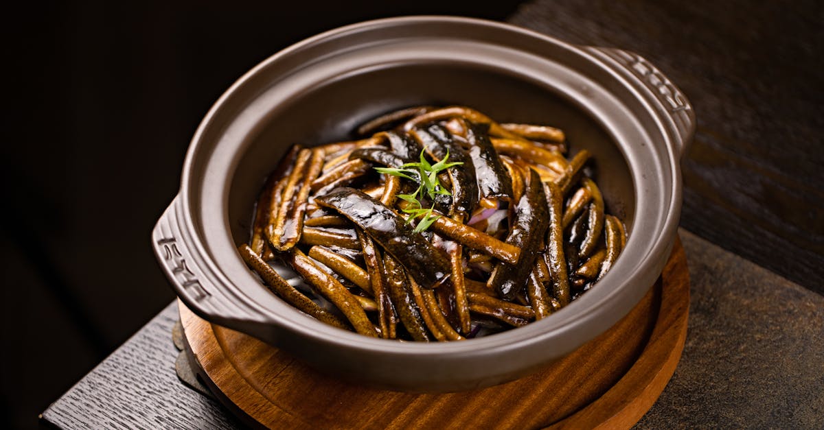 a gourmet asian eggplant dish served in a ceramic bowl perfect for food enthusiasts