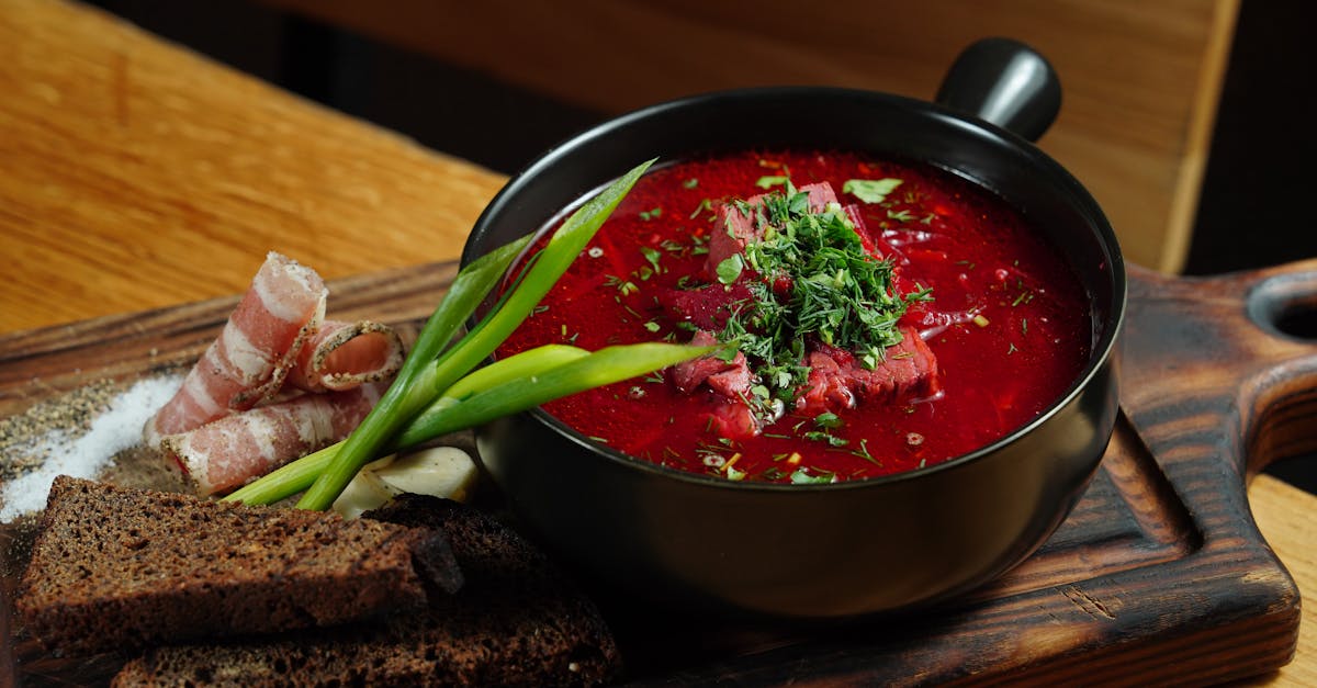 a hearty serving of borscht with rye bread and bacon styled on a rustic cutting board 3