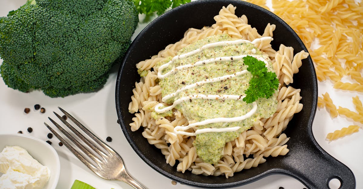 a mouthwatering dish of fusilli pasta topped with creamy broccoli sauce herbs and vegetables