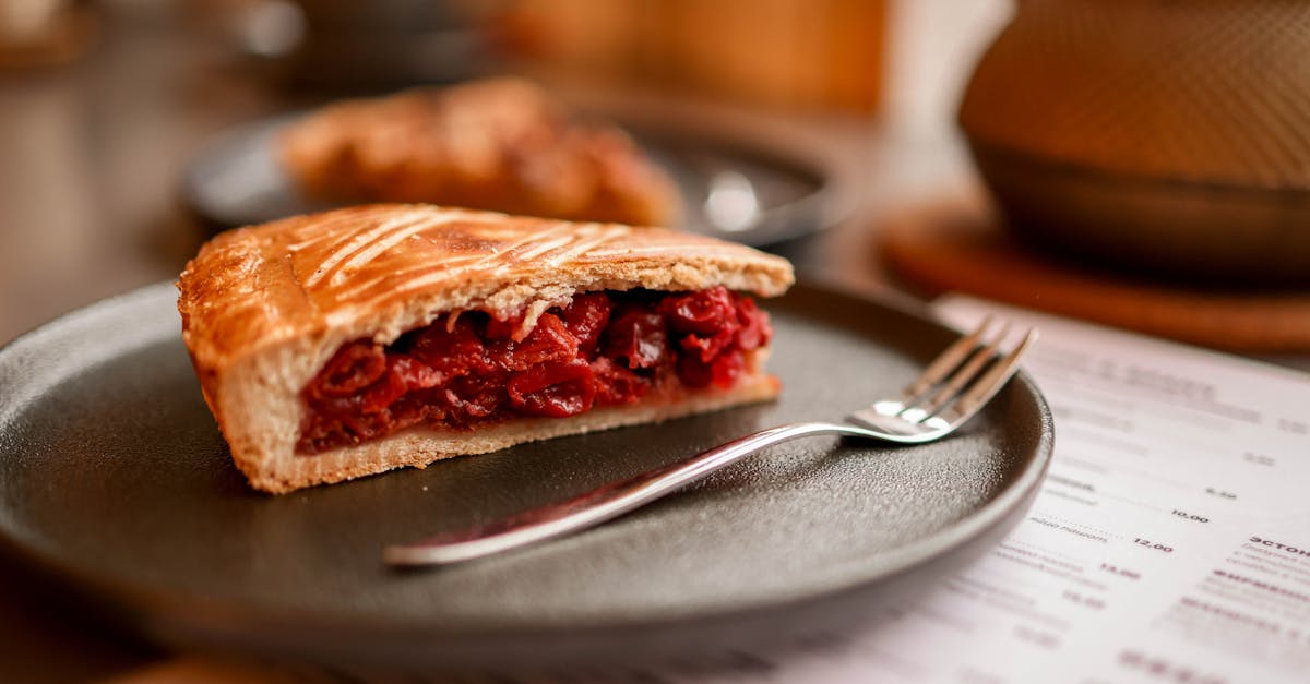 a mouthwatering slice of cherry pie served on a ceramic plate perfect for dessert lovers 1