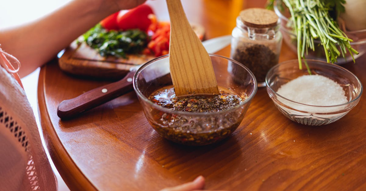 a person mixing chimichurri sauce with fresh herbs and spices in a kitchen setting 8