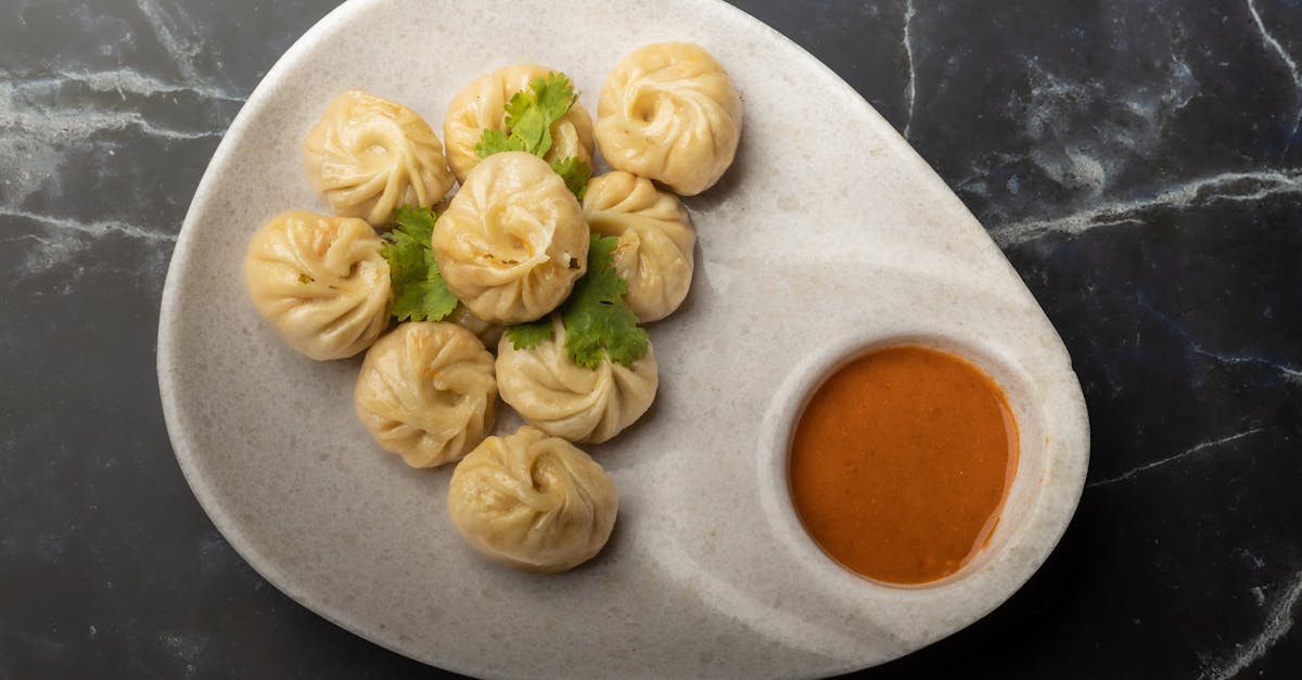 a plate of traditional nepalese momos with spicy chutney perfect for food enthusiasts seeking authe 1