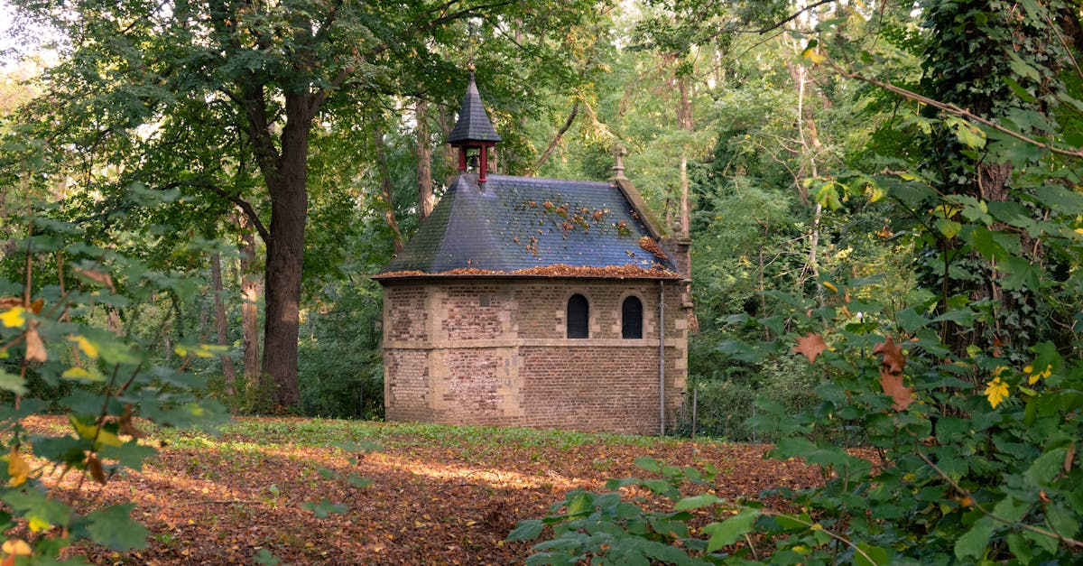 a quaint chapel surrounded by lush foliage in an autumn forest in sittard limburg netherlands
