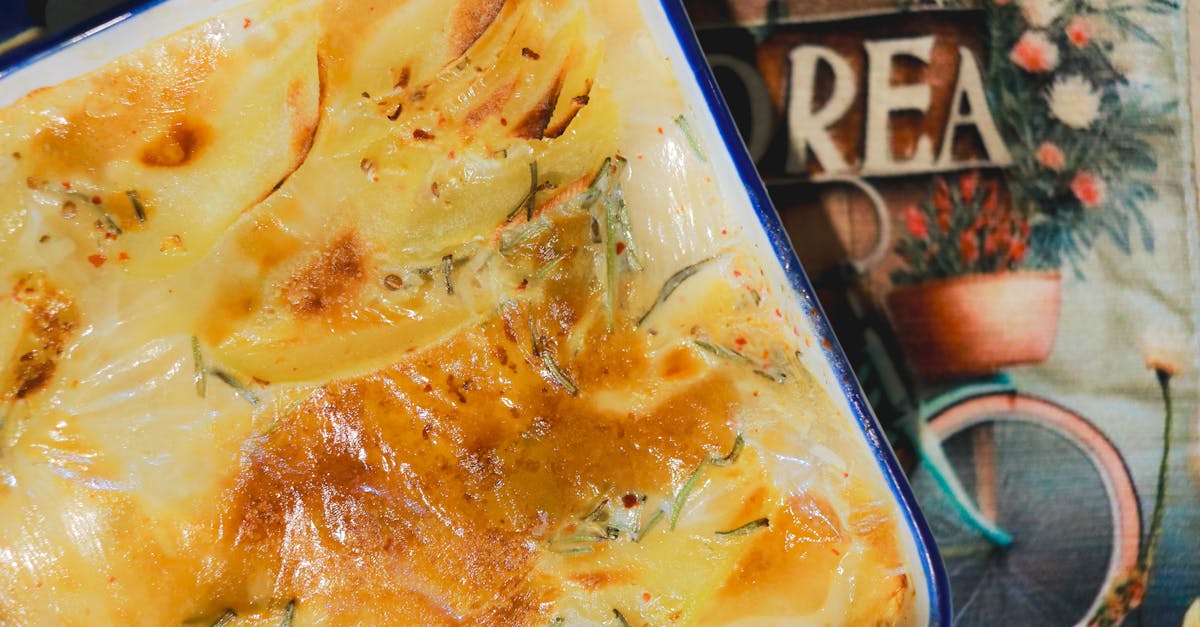 a rich and creamy potato gratin freshly baked golden and crispy in a ceramic dish