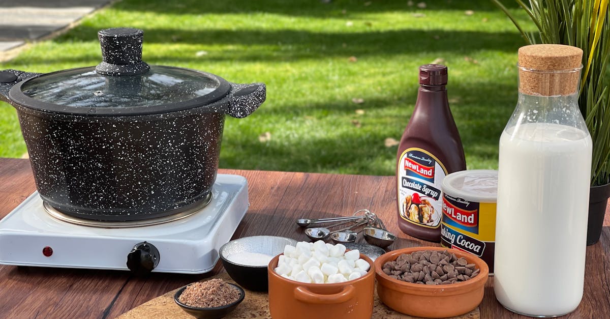 a rustic display of hot cocoa ingredients set outdoors with milk chocolate and a pot 1