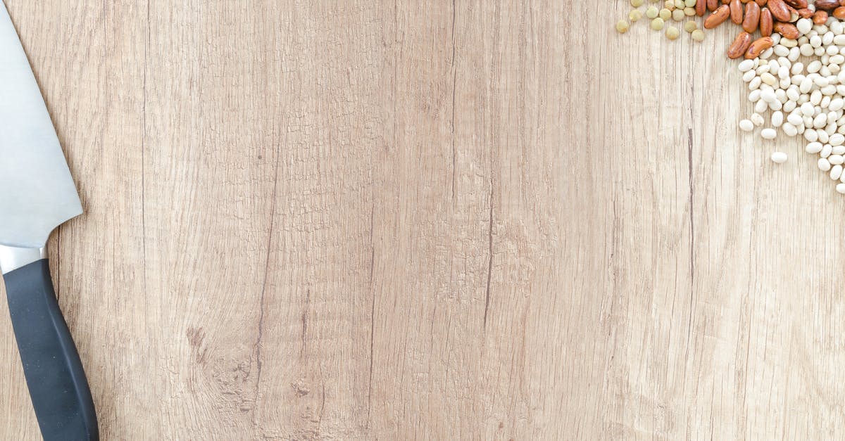 a rustic wooden surface with knife and an assortment of beans for cooking 1