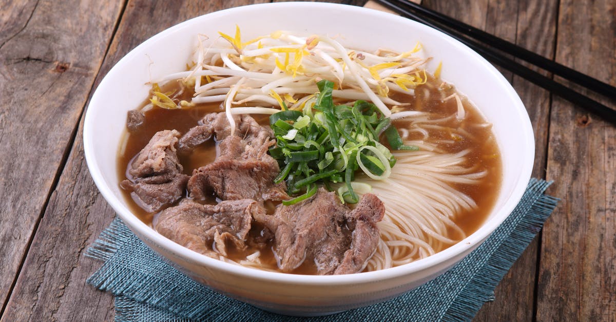 a savory bowl of vietnamese pho with beef noodles and fresh greens
