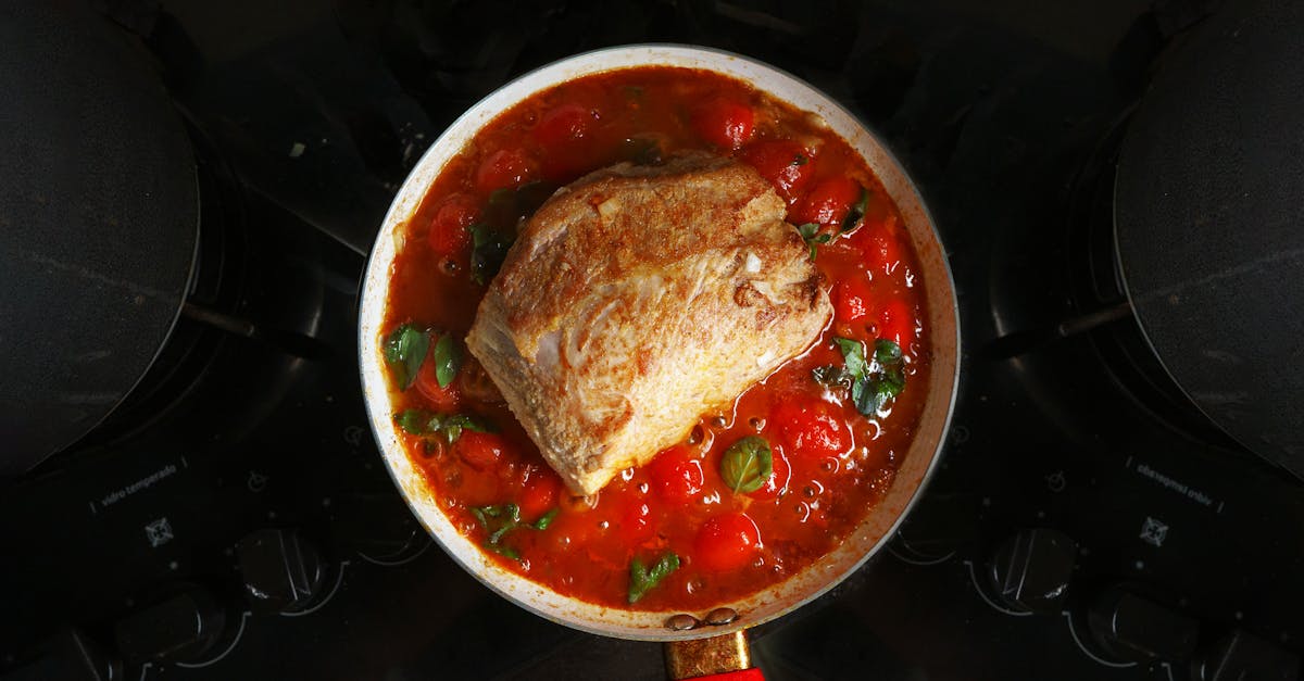 a savory roast beef cooked in rich tomato sauce with herbs atop a stovetop 7