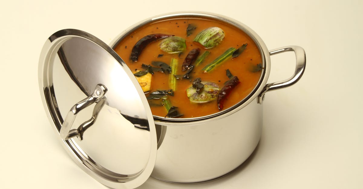 a savory south indian sambar with vegetables in a stainless steel pot capturing authentic flavors