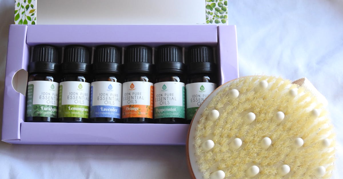 a selection of essential oils and a dry brush perfect for a relaxing spa day at home