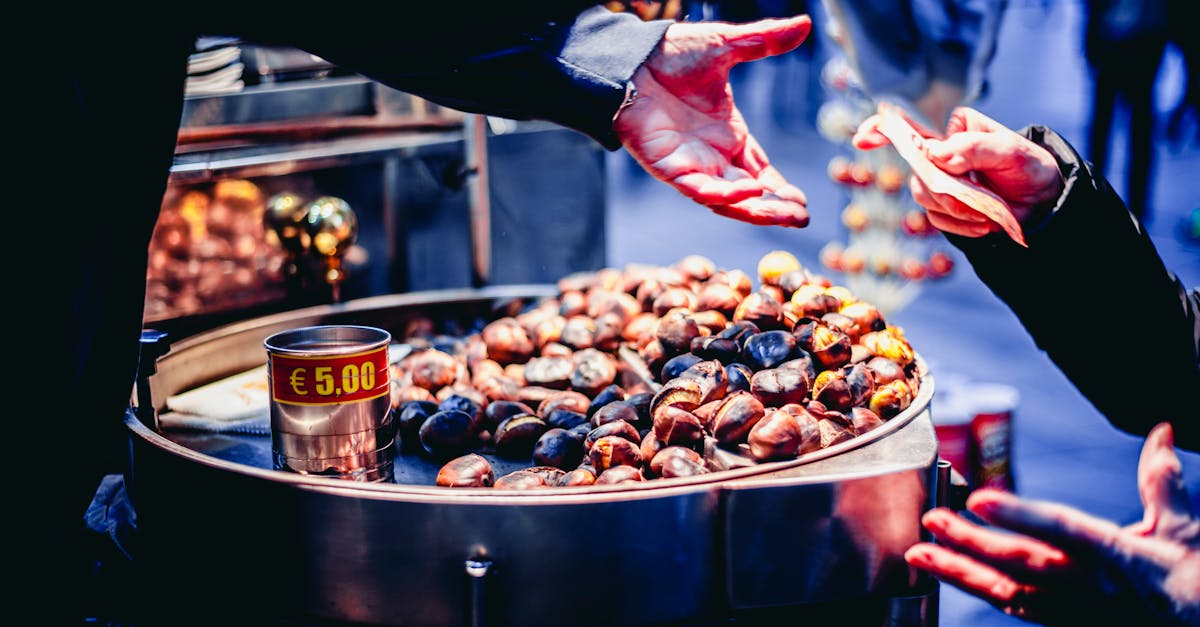 a street vendor selling roasted chestnuts to a customer on a lively outdoor market