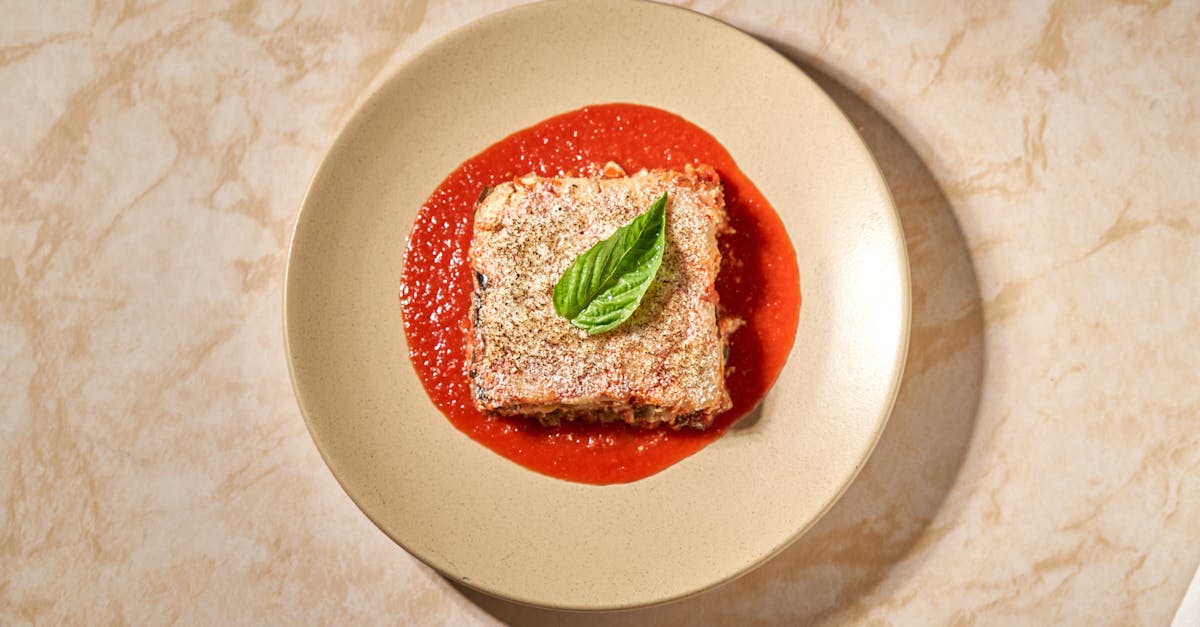 a tasty eggplant parmesan dish served with tomato sauce and basil