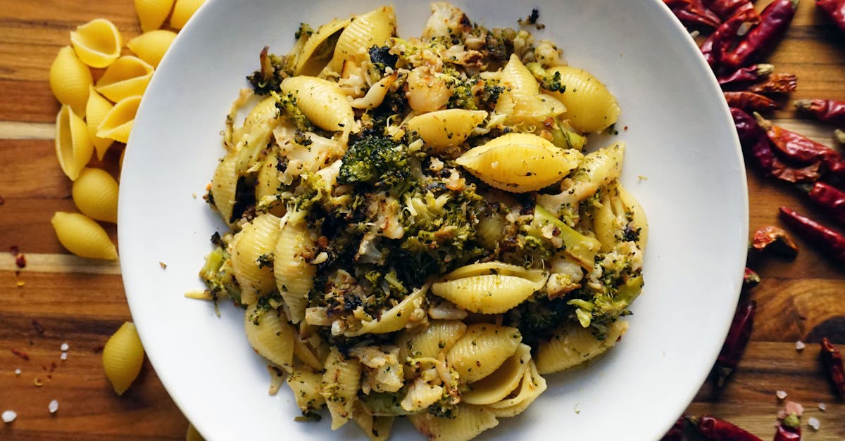 a tempting bowl of shell pasta mixed with broccoli and chili peppers on a rustic wooden table 18