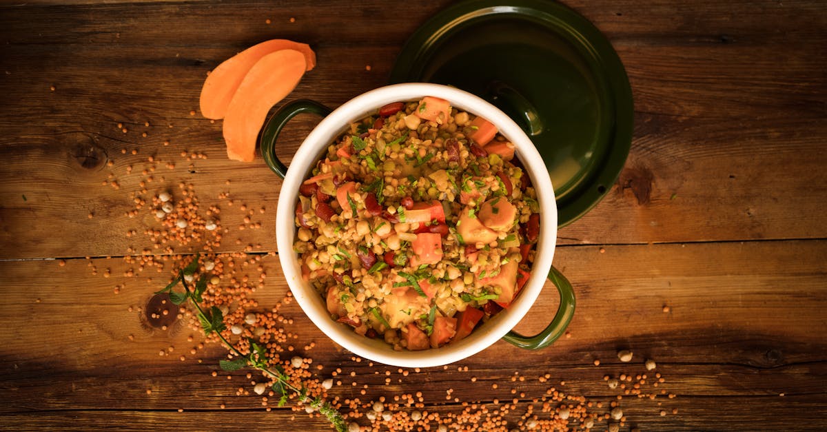 a top down view of a colorful lentil and vegetable stew in a green pot perfect for healthy meals 1