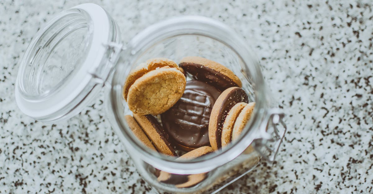 a top view of a glass jar filled with delicious chocolate cookies on a granite countertop 1