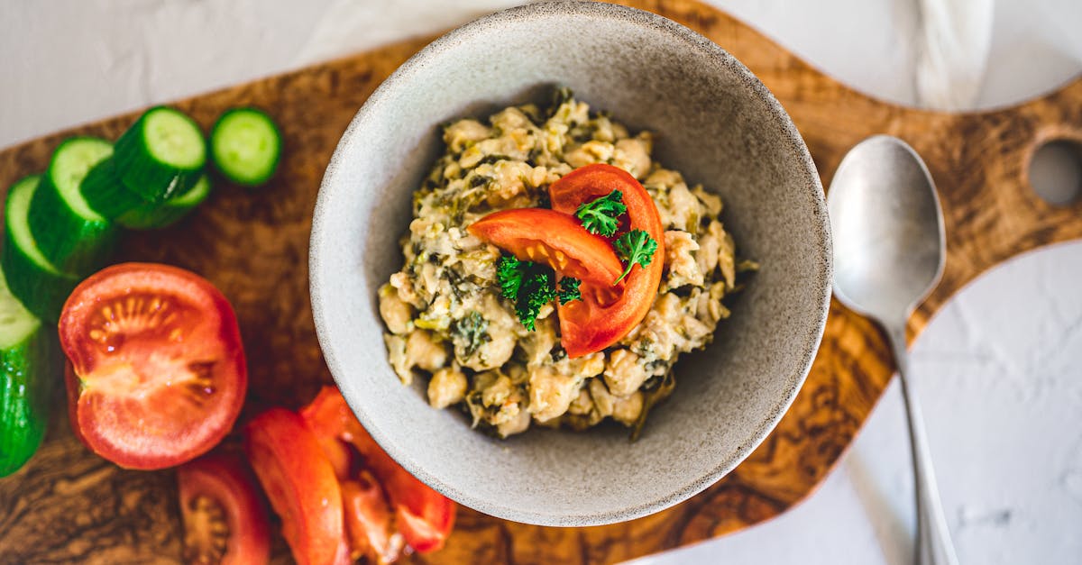 a top view of a nutritious chickpea salad with fresh tomatoes and cucumbers on a wooden board