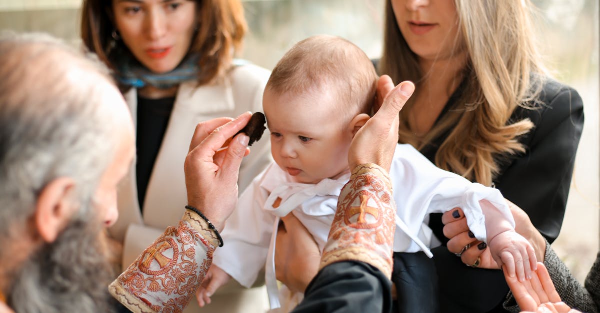 a touching moment during a baby s baptism showcasing family and religious traditions