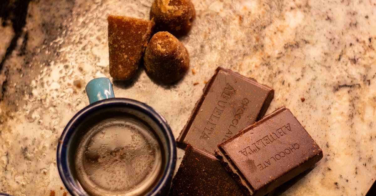 a traditional mexican cup of cafe de olla with chocolate and piloncillo on a rustic surface