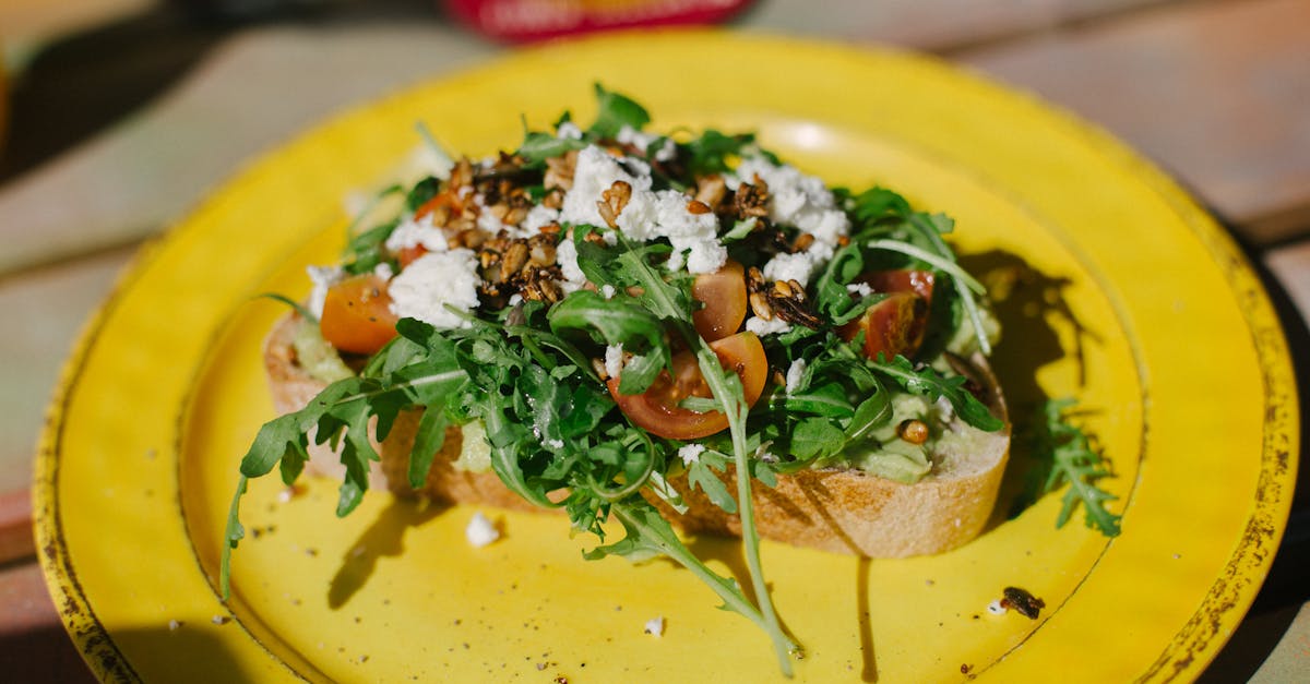 a vibrant and healthy avocado toast topped with cherry tomatoes arugula and feta cheese on a yello