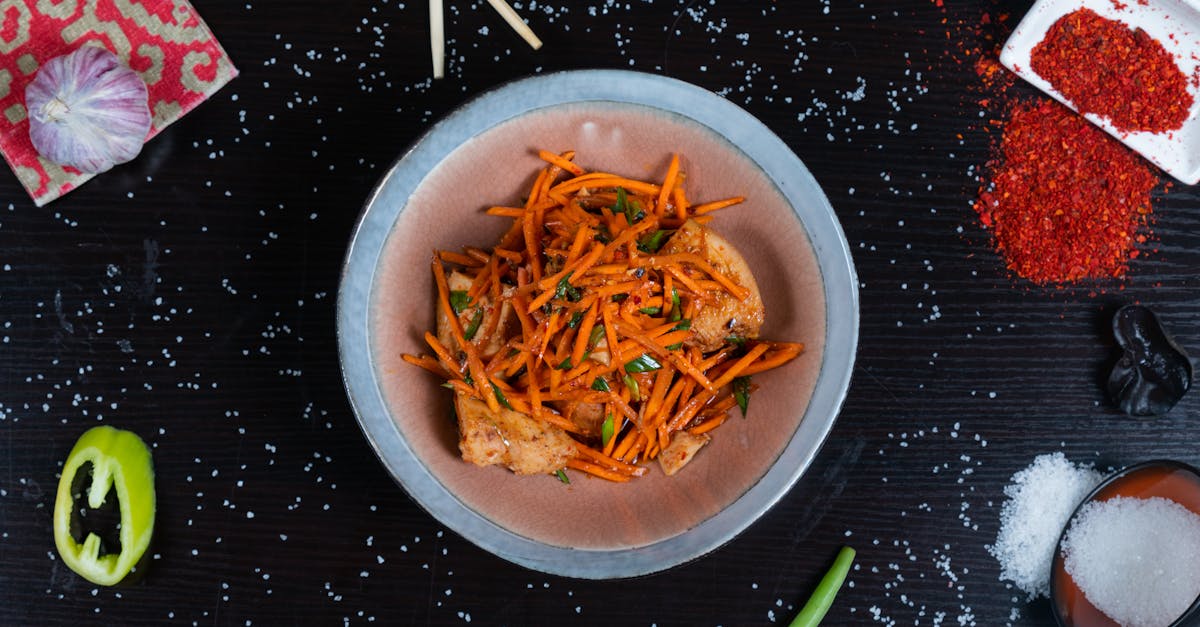 a vibrant and spicy carrot and fish stir fry garnished with fresh herbs and spices