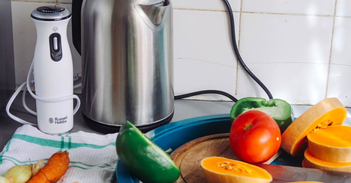 a vibrant array of fresh vegetables with a kettle and a blender on a kitchen countertop ideal for h