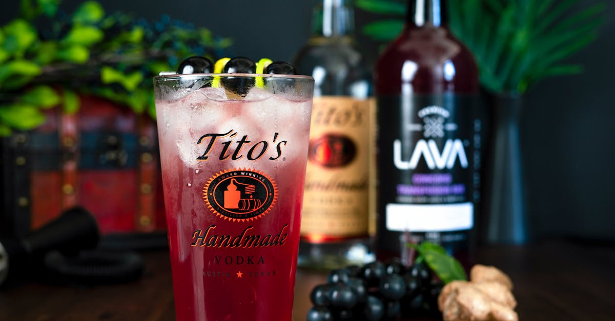 a vibrant berry cocktail featuring tito s handmade vodka garnished with grapes