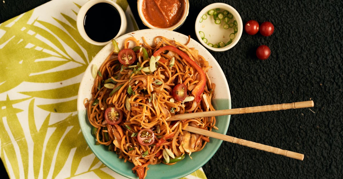 a vibrant bowl of noodles with fresh vegetables and accompanying sauces perfect for food photograph 1