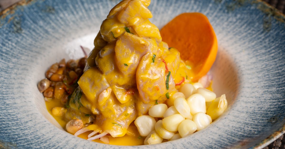a vibrant dish of peruvian ceviche featuring corn and sweet potato on a decorative blue plate