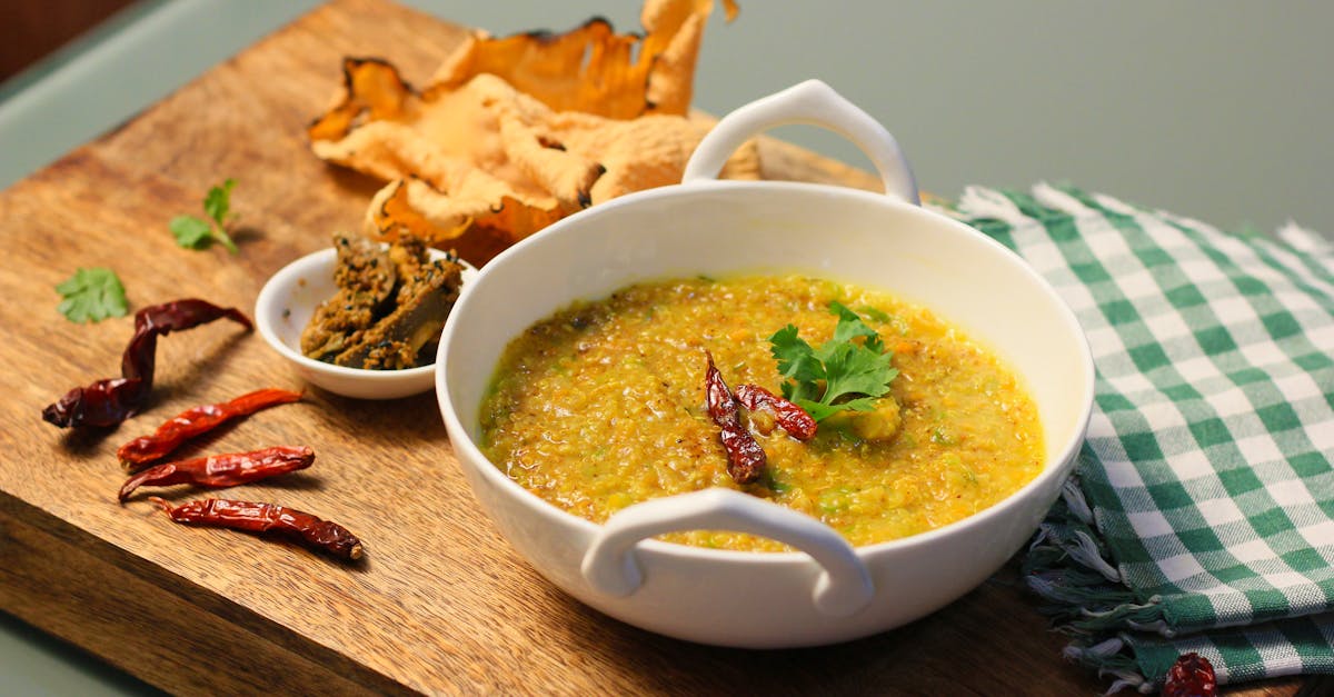 a vibrant indian khichdi dish served with chilies and papad perfect for a spicy meal