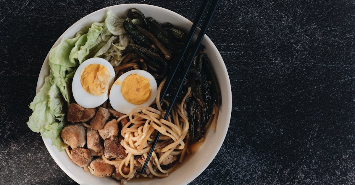 a vibrant ramen bowl with chopsticks noodles eggs and vegetables captured in a top view 2