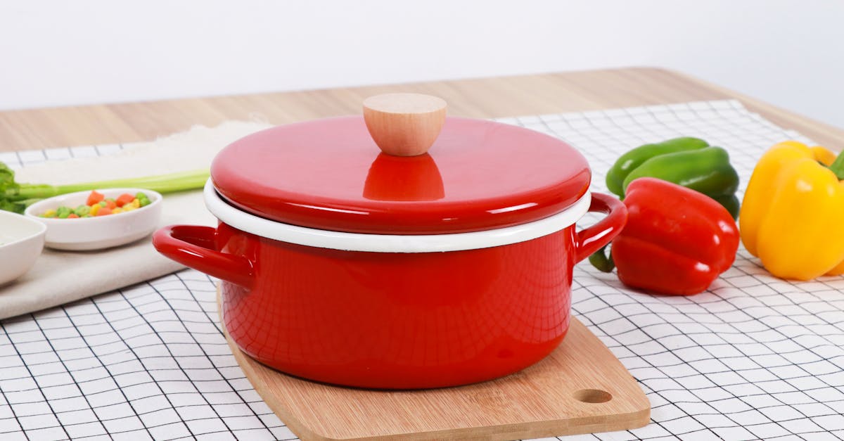 a vibrant red cooking pot with bell peppers on a checked table for a culinary setup 3