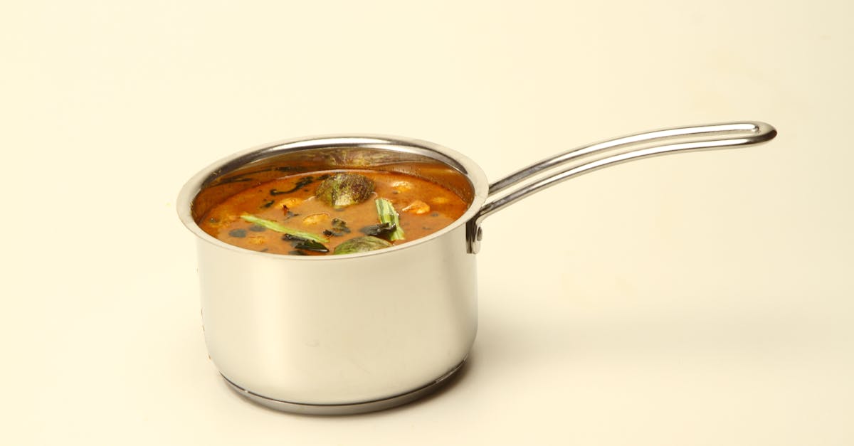 a vibrant south indian sambar with vegetables in a stainless saucepan ideal for culinary themes 4