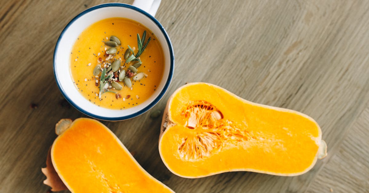 a warm homemade butternut squash soup garnished with seeds and rosemary 4